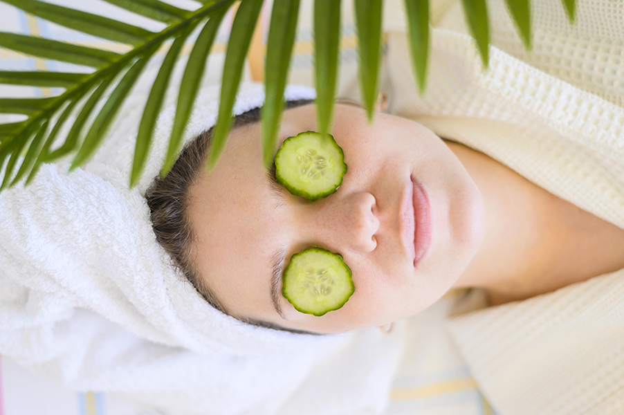 top-view-woman-with-cucumber-slices-eyes